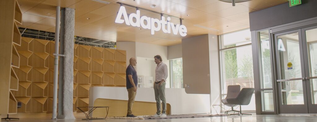 Chad and Harlan Robins stand in the lobby of Adaptive's Seattle HQ